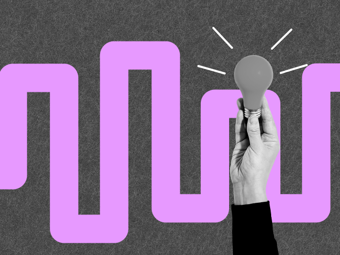 Hånd, der holder en elpære